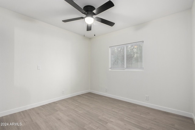 unfurnished room with ceiling fan, baseboards, and light wood-style floors