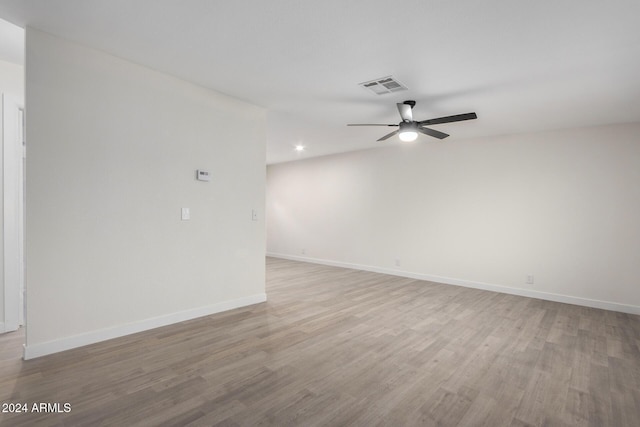 spare room featuring ceiling fan, baseboards, visible vents, and light wood-type flooring