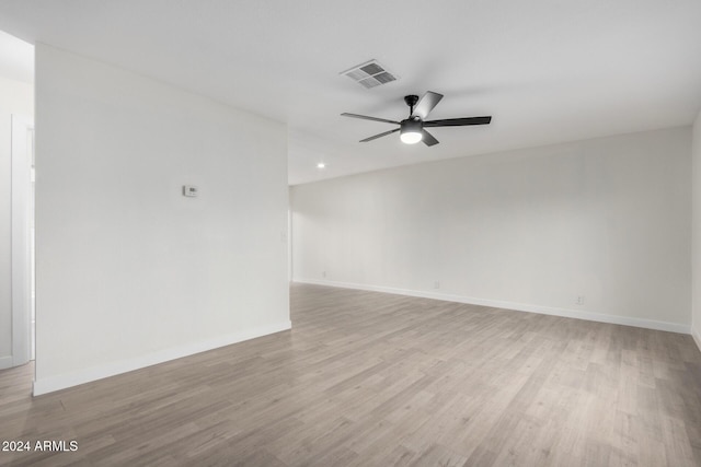 unfurnished room with visible vents, baseboards, light wood-type flooring, and ceiling fan