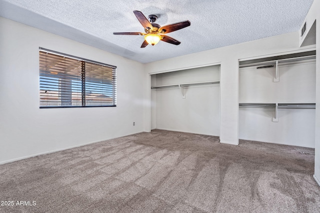 3747 W Aire Libre Ave, Phoenix, AZ 85053 - unfurnished bedroom with multiple closets, a textured ceiling, carpet floors, and a ceiling fan