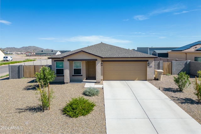 view of front of home with a garage and a mountain view