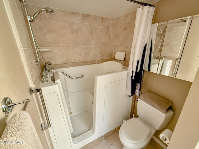 bathroom featuring toilet, tile patterned floors, and shower / bath combo