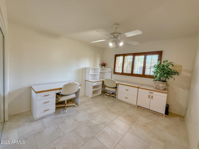 unfurnished office featuring ceiling fan