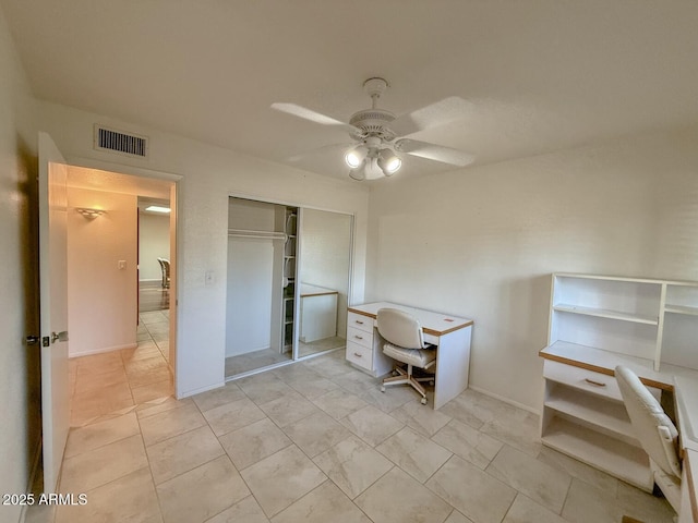 unfurnished office featuring ceiling fan