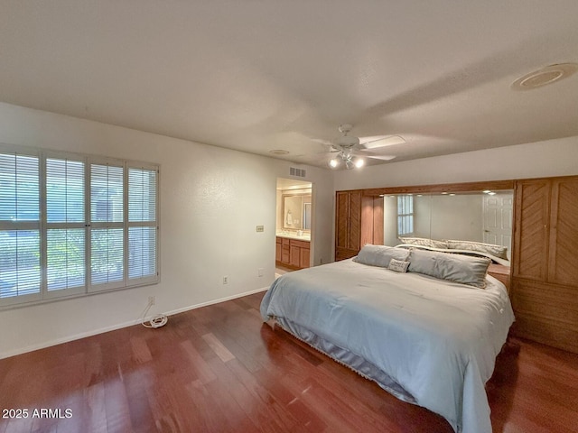 bedroom featuring ensuite bathroom, ceiling fan, and dark hardwood / wood-style flooring