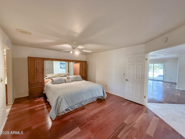 bedroom with hardwood / wood-style floors and ceiling fan