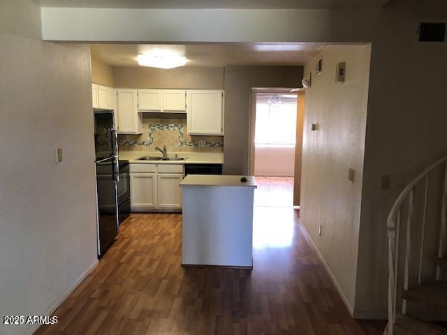 kitchen with white cabinetry, sink, backsplash, dark hardwood / wood-style flooring, and fridge