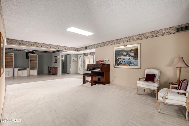 living area featuring a textured ceiling, visible vents, and carpet flooring