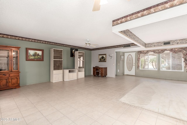 unfurnished living room with ceiling fan, beam ceiling, a textured ceiling, and visible vents