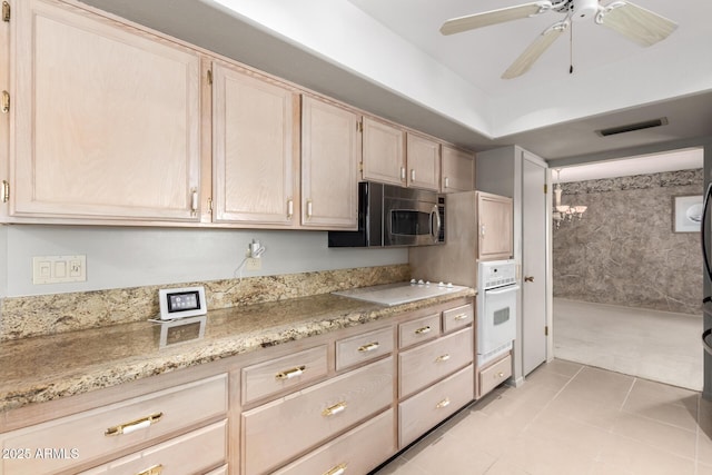 kitchen featuring ceiling fan, light tile patterned floors, white appliances, visible vents, and light brown cabinetry