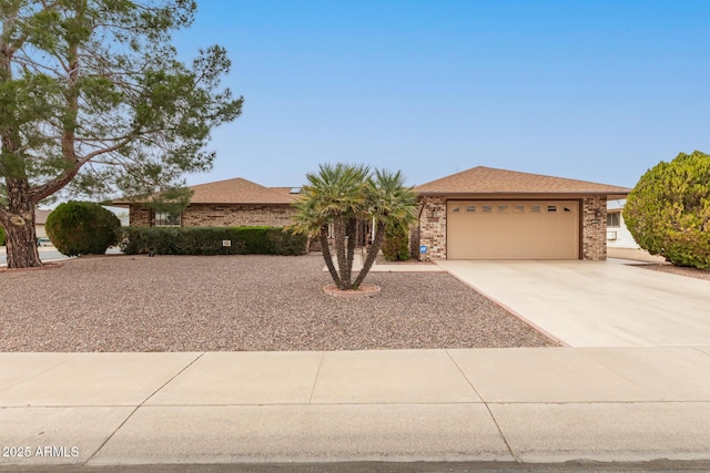 view of front of property featuring driveway, brick siding, an attached garage, and a shingled roof