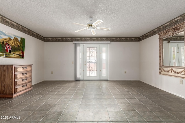 unfurnished living room featuring a textured ceiling, ceiling fan, tile patterned flooring, and baseboards