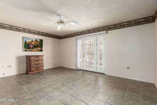 empty room featuring a ceiling fan, a textured ceiling, baseboards, and tile patterned floors