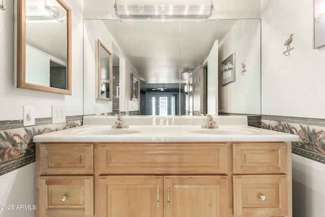 bathroom featuring a sink and double vanity