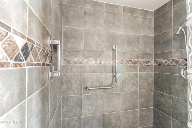 bathroom with a tile shower