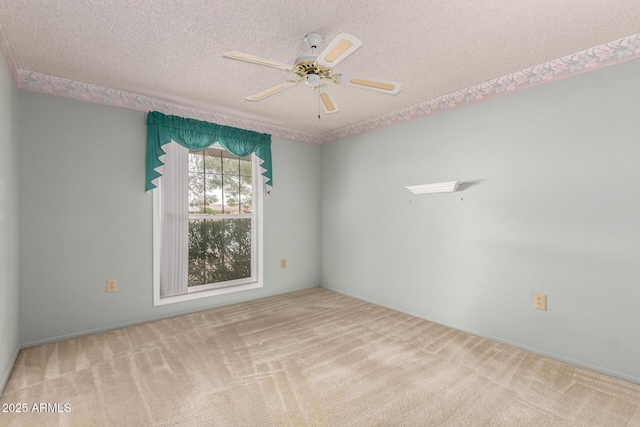 spare room with ceiling fan, a textured ceiling, and carpet flooring