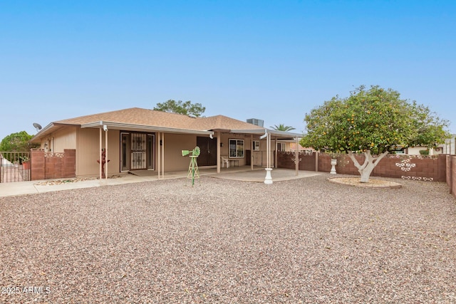 back of property featuring a patio area and fence