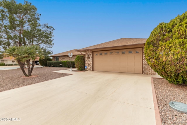 ranch-style house featuring a garage, brick siding, and driveway