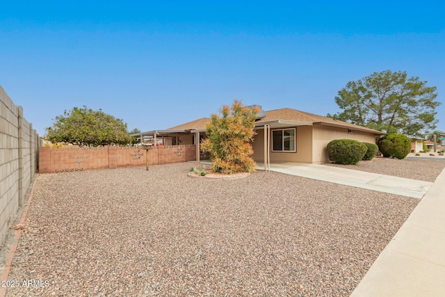 view of front of house with a patio area and fence