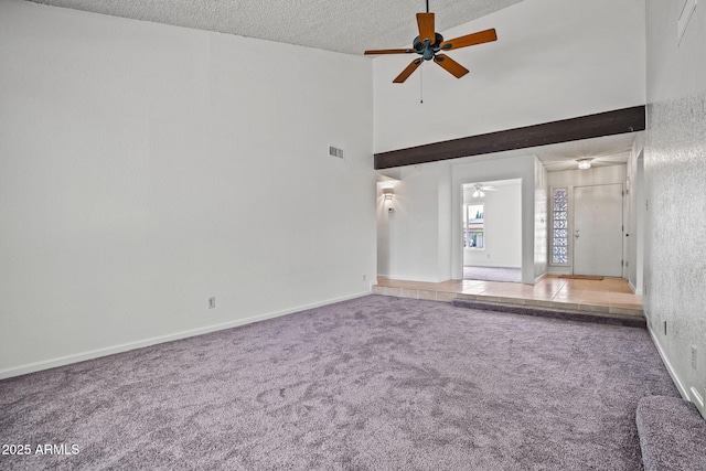 interior space with ceiling fan, a textured ceiling, visible vents, carpet floors, and high vaulted ceiling