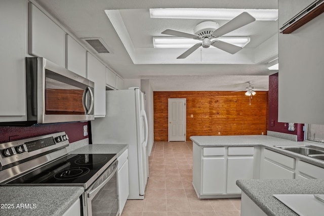 kitchen featuring light tile patterned floors, appliances with stainless steel finishes, a ceiling fan, and white cabinetry
