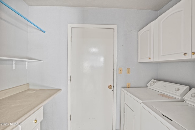 laundry area featuring cabinet space and washing machine and clothes dryer