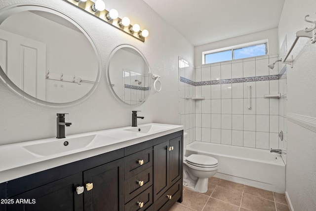 bathroom featuring a sink, toilet, double vanity, and shower / washtub combination