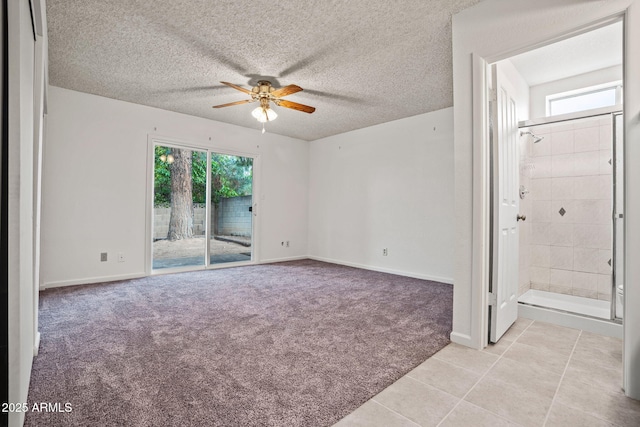 spare room with light carpet, baseboards, a textured ceiling, a ceiling fan, and light tile patterned floors