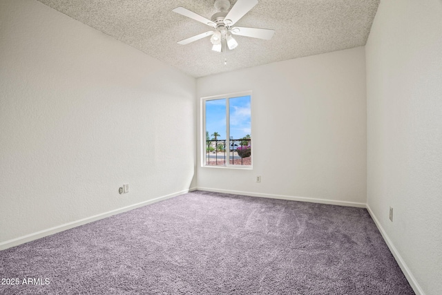 spare room with a ceiling fan, a textured ceiling, baseboards, and carpet