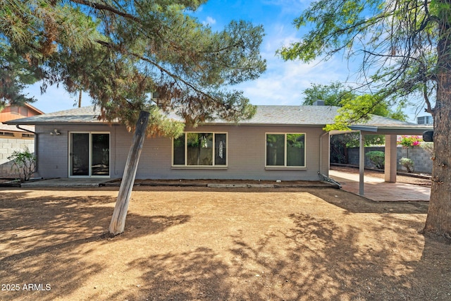 back of house with a patio and fence