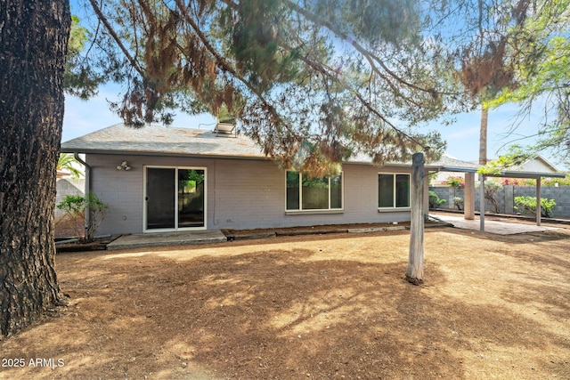 rear view of property with fence, a patio, a gazebo, and brick siding