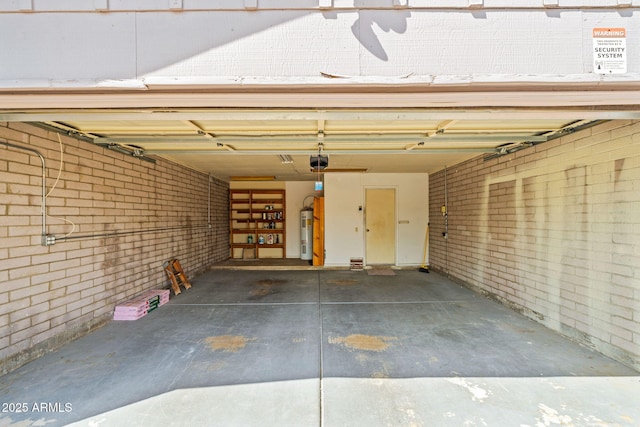 garage with a garage door opener and electric water heater