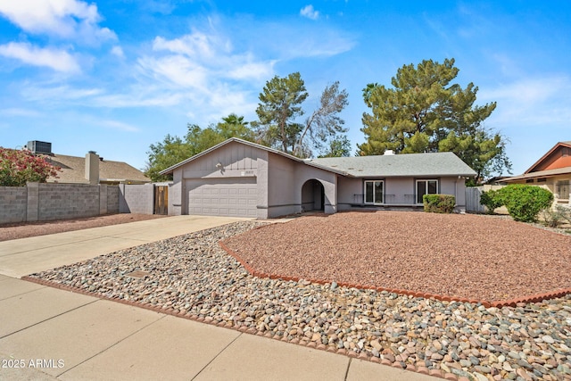 single story home with fence, an attached garage, and concrete driveway