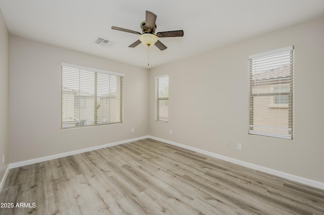 41715 N Raleigh Ct, Anthem, AZ 85086 - spare room featuring a ceiling fan, wood finished floors, and baseboards