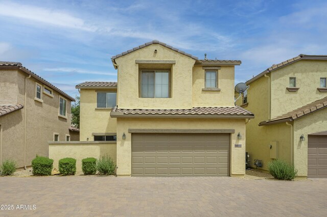 41715 N Raleigh Ct, Anthem, AZ 85086 - view of front facade featuring a tiled roof, a garage, stucco siding, and decorative driveway