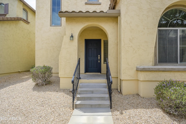 41715 N Raleigh Ct, Anthem, AZ 85086 - doorway to property with stucco siding and an AC wall unit