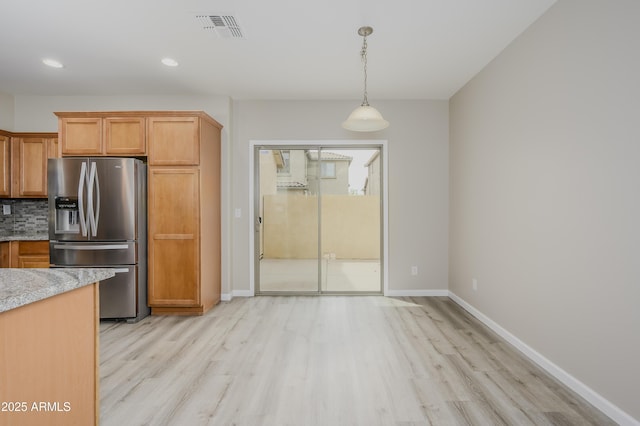 41715 N Raleigh Ct, Anthem, AZ 85086 - kitchen featuring stainless steel fridge, light wood-type flooring, baseboards, tasteful backsplash, and recessed lighting