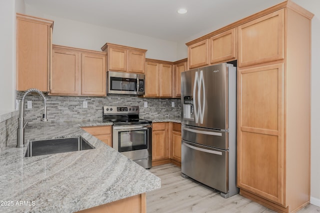 41715 N Raleigh Ct, Anthem, AZ 85086 - kitchen featuring stainless steel appliances, a sink, light stone countertops, and recessed lighting