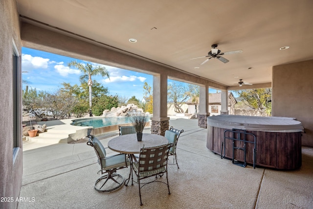 view of patio / terrace featuring ceiling fan and a swimming pool with hot tub