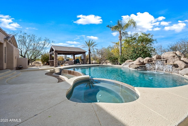 view of swimming pool with a gazebo, pool water feature, an in ground hot tub, and a patio area