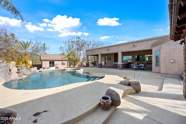 view of swimming pool featuring a patio area, an outdoor structure, and ceiling fan