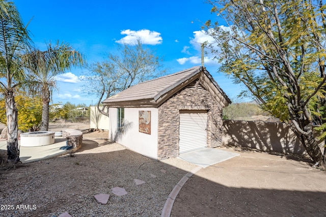 view of property exterior featuring an outbuilding and a garage