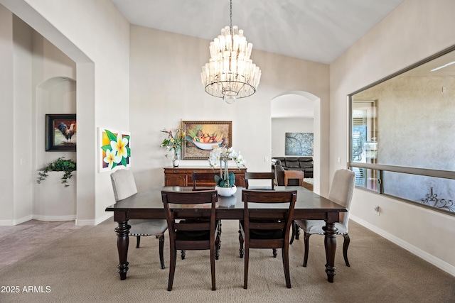 dining area with a notable chandelier and carpet floors