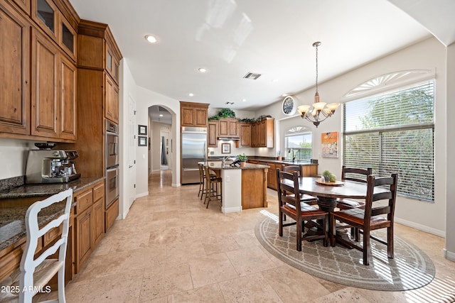 dining room featuring sink and a notable chandelier