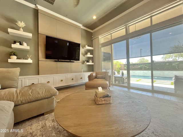 living room with visible vents and ornamental molding