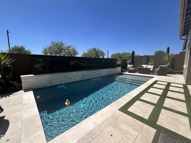 view of swimming pool with a fenced in pool, a patio area, and a fenced backyard