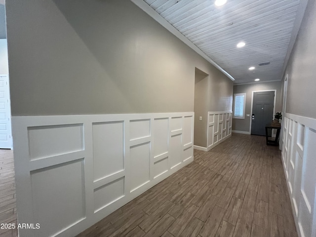 hall featuring recessed lighting, dark wood-style flooring, visible vents, wainscoting, and crown molding