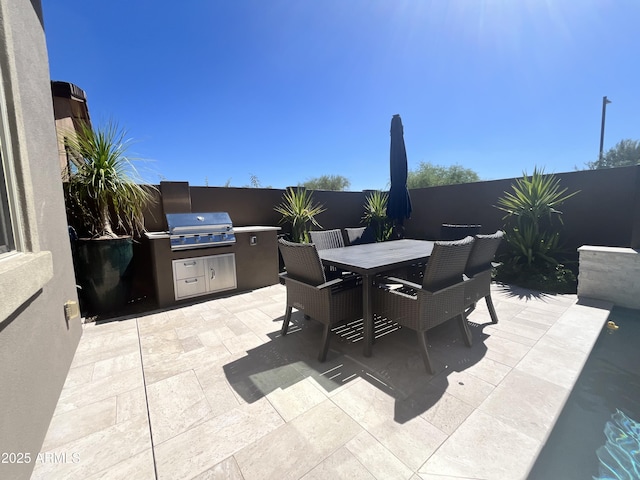 view of patio / terrace with outdoor dining area, fence, and area for grilling