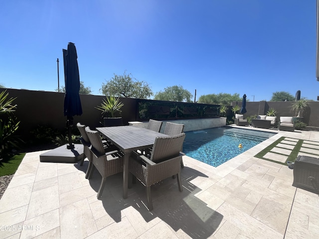 view of pool with a fenced in pool, outdoor dining area, a patio, an outdoor hangout area, and a fenced backyard