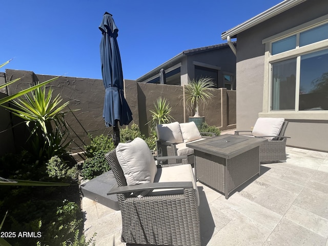 view of patio featuring an outdoor hangout area and fence